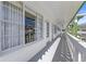 Long, covered condo balcony features white railings, and unit numbers at 2468 Florentine Way # 52, Clearwater, FL 33763