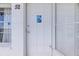 Clean white front door with security system and decorative glass at 2468 Florentine Way # 52, Clearwater, FL 33763