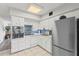 Functional kitchen with stainless steel appliances, white cabinets, and tiled flooring at 2468 Florentine Way # 52, Clearwater, FL 33763