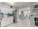 Bright kitchen and adjacent dining area with modern appliances, tiled floors, and natural light at 2468 Florentine Way # 52, Clearwater, FL 33763