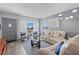 Inviting living room with contemporary decor and comfortable white leather seating at 2468 Florentine Way # 52, Clearwater, FL 33763