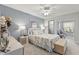 Comfortable main bedroom with a coral patterned bed, decorative lamps, and a glimpse into an en-suite bathroom at 2468 Florentine Way # 52, Clearwater, FL 33763