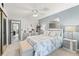 Inviting main bedroom with a coastal themed bed, soft blue walls, and stylish furnishings at 2468 Florentine Way # 52, Clearwater, FL 33763