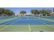 Multiple tennis courts with blue and green surfacing for active community members at 2468 Florentine Way # 52, Clearwater, FL 33763