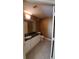 Clean bathroom with granite countertop, white cabinets, and tiled floors at 2757 Via Cipriani # 1114A, Clearwater, FL 33764