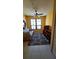 Bright bedroom with a ceiling fan, large window, and built in shelving at 2757 Via Cipriani # 1114A, Clearwater, FL 33764