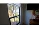 Bedroom with a large window showcasing a leafy backyard view at 2757 Via Cipriani # 1114A, Clearwater, FL 33764