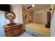 Bedroom with a dresser, ceiling fan, and a yellow bedspread at 2757 Via Cipriani # 1114A, Clearwater, FL 33764