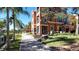 Building exterior showcasing a pathway, landscaping, and waterfront views at 2757 Via Cipriani # 1114A, Clearwater, FL 33764