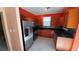 Modern kitchen with stainless steel appliances and wood cabinets at 2757 Via Cipriani # 1114A, Clearwater, FL 33764