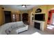 Living room featuring a fireplace, sectional sofa, and built-in shelving at 2757 Via Cipriani # 1114A, Clearwater, FL 33764