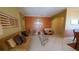 Living room with tiled floors, orange accent wall, and comfortable seating at 2757 Via Cipriani # 1114A, Clearwater, FL 33764