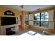 Living room with a fireplace, built-in shelving, and waterfront views at 2757 Via Cipriani # 1114A, Clearwater, FL 33764
