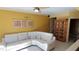 Spacious living room featuring a sectional sofa and built-in cabinet at 2757 Via Cipriani # 1114A, Clearwater, FL 33764