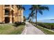 Brick pathway meanders along waterfront with palm trees at 2757 Via Cipriani # 1114A, Clearwater, FL 33764