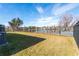 Fenced backyard with pond view and grassy area at 30509 Pecan Valley Loop, Wesley Chapel, FL 33543