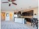 Open concept kitchen with granite countertops and dark wood cabinets at 30509 Pecan Valley Loop, Wesley Chapel, FL 33543