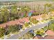 Aerial view highlighting the home's position in a community near lush greenery at 3985 Mermoor Dr, Palm Harbor, FL 34685