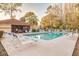 Community pool with surrounding lounge chairs at 3985 Mermoor Dr, Palm Harbor, FL 34685