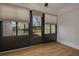 Sunroom with wood flooring, large windows, and access to the deck at 3985 Mermoor Dr, Palm Harbor, FL 34685