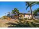 Landscaped backyard with pool and canal view at 3998 South Cir, Largo, FL 33774