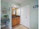 Powder room with granite countertop and wood cabinets at 3998 South Cir, Largo, FL 33774