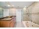 Bathroom with a double vanity, soaking tub and shower at 3998 South Cir, Largo, FL 33774