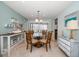 Casual dining area with glass-top table and four chairs at 3998 South Cir, Largo, FL 33774