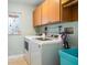 Laundry room with washer, dryer, and cabinets at 3998 South Cir, Largo, FL 33774