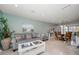 Comfortable living room featuring a gray sofa, coffee table, and dining area at 3998 South Cir, Largo, FL 33774