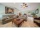 Bright living room with comfortable seating and views to the pool at 3998 South Cir, Largo, FL 33774