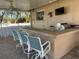 Outdoor kitchen with bar seating and grill at 3998 South Cir, Largo, FL 33774