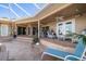Relaxing covered patio with wicker furniture and steps leading to the pool at 3998 South Cir, Largo, FL 33774