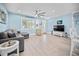 This is a bright and airy living room featuring modern furnishings, lots of windows, and tile flooring at 421 77Th Ave, St Pete Beach, FL 33706