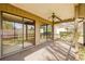 Spacious screened porch with sliding glass doors and a ceiling fan at 4654 Oak Hill Ln # 38, Sarasota, FL 34232