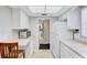 Well-lit kitchen featuring white cabinets and appliances with tile floor at 5020 Brittany S Dr # 123, St Petersburg, FL 33715