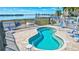 Inviting community hot tub overlooks a beautiful waterfront view with lounge chairs for relaxing and enjoying the outdoors at 5020 Brittany S Dr # 123, St Petersburg, FL 33715