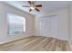 Simple bedroom with ceiling fan and large window at 5107 Lady Rose Ct, Lutz, FL 33558