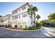 White townhome with garage, palm trees, and a quiet street at 6002 Yeats Manor Dr # 101, Tampa, FL 33616