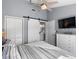 Bedroom with a barn door leading to the bathroom at 6191 Bahia Del Mar Blvd # 201, St Petersburg, FL 33715