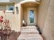 Inviting house entrance with tiled steps, a bench, and a door with a decorative glass insert at 631 12Th N Ave, Safety Harbor, FL 34695