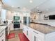 Kitchen features white cabinets, granite island, and stainless steel appliances at 631 12Th N Ave, Safety Harbor, FL 34695