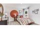 Bedroom with a bohemian feel, featuring a round wall accent and cozy bedding at 6963 Broad River Ave, Land O Lakes, FL 34638