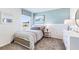 Bedroom with wood-toned bed, dresser, and window with natural light at 6963 Broad River Ave, Land O Lakes, FL 34638