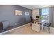 L-shaped desk and gray accent wall in this home office at 6987 Broad River Ave, Land O Lakes, FL 34638