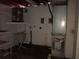 Unfinished basement area with water heater and shelving at 7314 Patio Row, Hudson, FL 34667