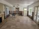 Renovation project: Dining area with tile floor, exposed framing, and fireplace at 812 Bohenia N Cir, Clearwater Beach, FL 33767