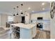 Modern kitchen with white cabinets, large island, and stainless steel appliances at 8408 Abalone Loop, Parrish, FL 34219