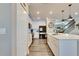 Modern kitchen with white cabinets, center island, and stainless steel appliances at 8408 Abalone Loop, Parrish, FL 34219