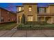 Two-story townhome with landscaping, a green door, and a sidewalk at 8729 Sheldon Creek Blvd, Tampa, FL 33615